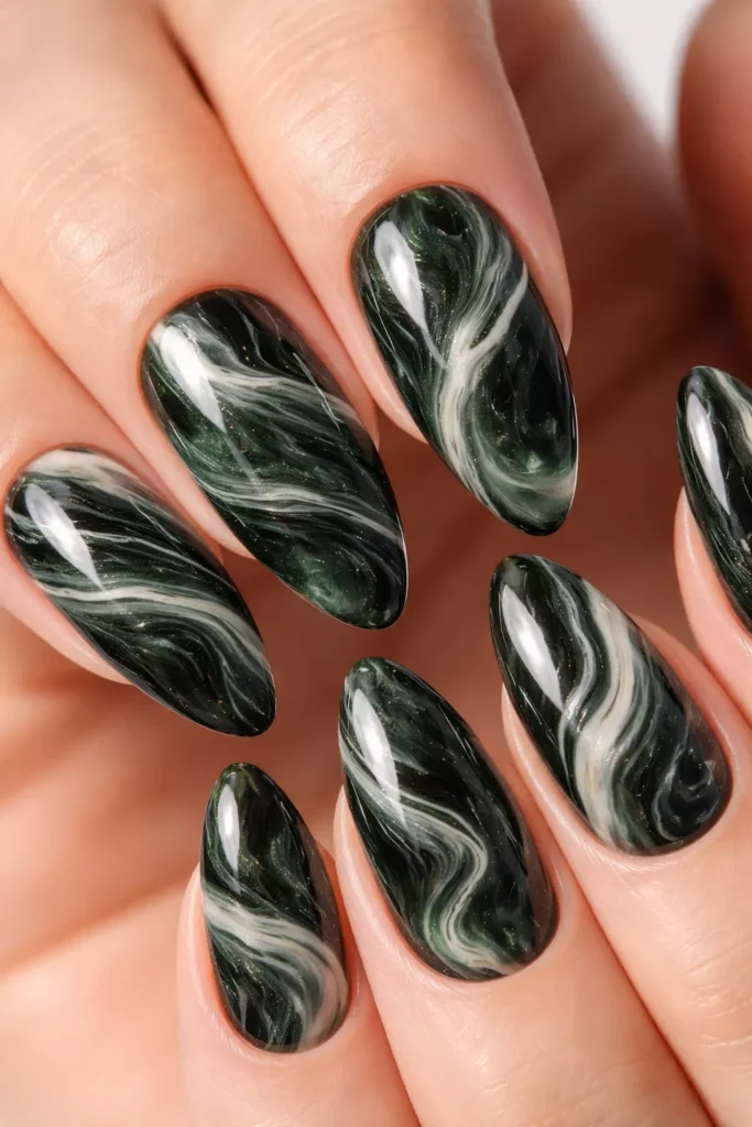 Almond nails with dark green marble swirl design