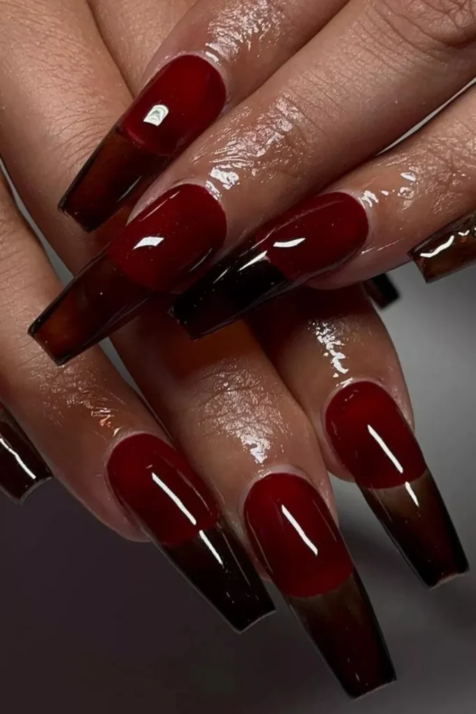 Extra long coffin nails with a translucent deep burgundy red "jelly" finish.