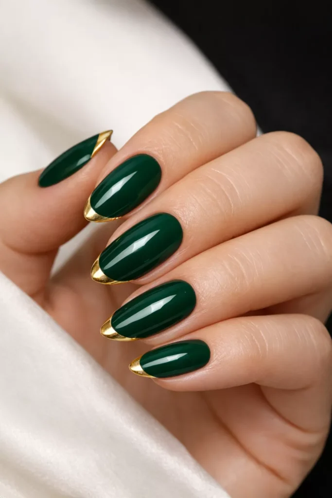 Almond emerald nails with thin gold French tips