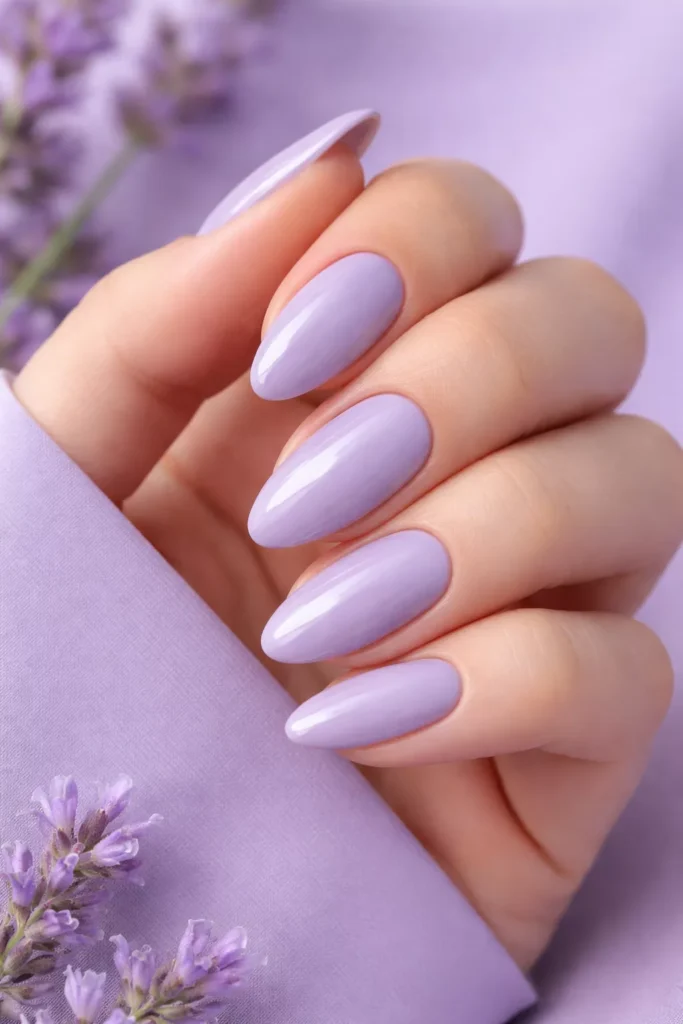 Glossy soft lavender oval-shaped summer nails.