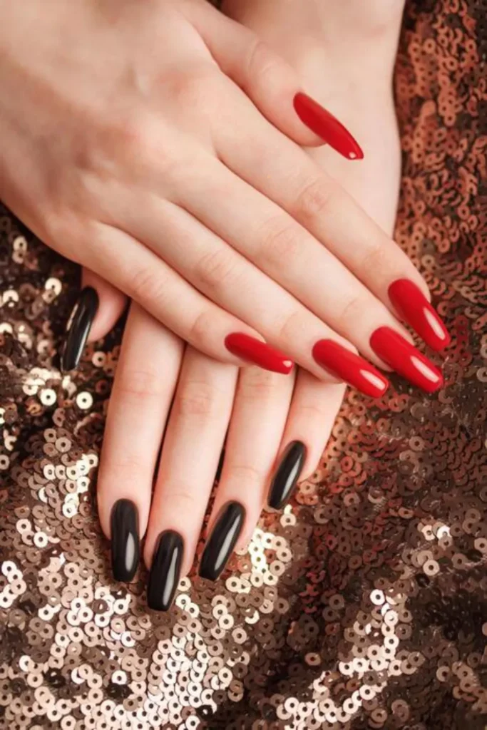 ong, square-shaped nails featuring a high-gloss finish, with one hand sporting a bold classic red and the other a sleek jet black, resting against a bronze sequined background.