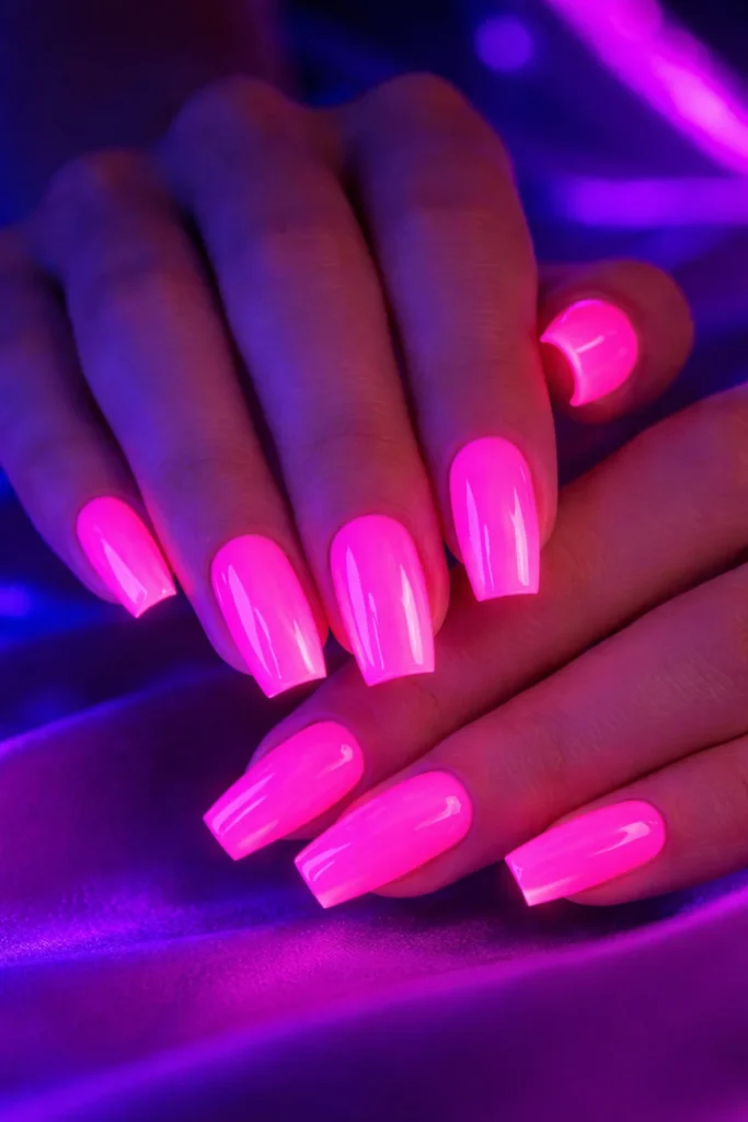 Neon pink gel nails with UV glow effect, statement pink nail ideas 2026.