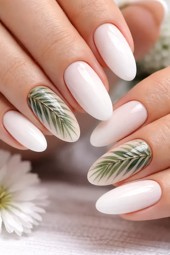 Nude nails featuring green tropical palm leaf accents.