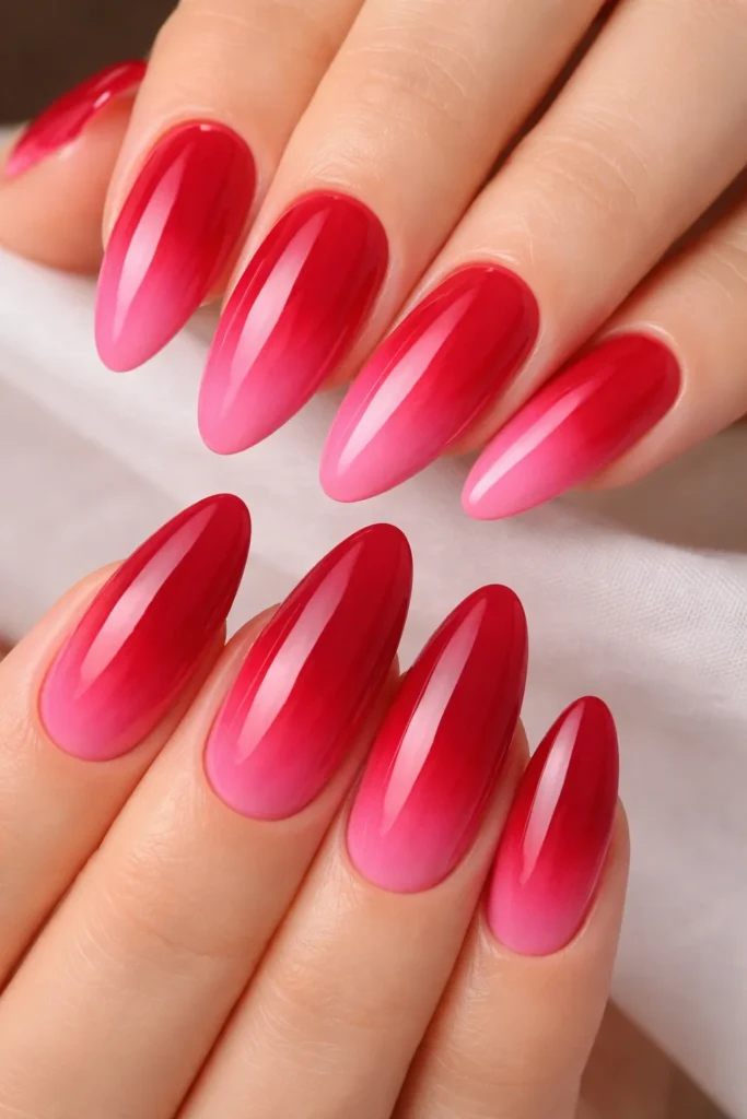 Pink and red ombré nails blending deep red into vibrant pink nail ideas.