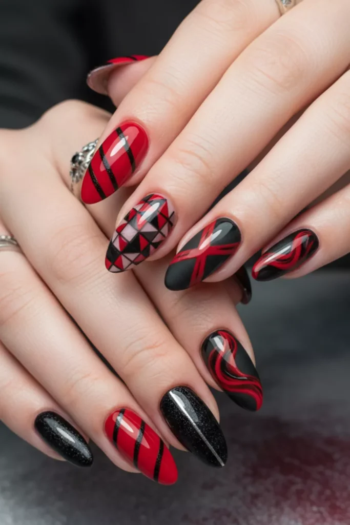 Close-up of almond-shaped nails with intricate red and black geometric patterns, stripes, and swirls.