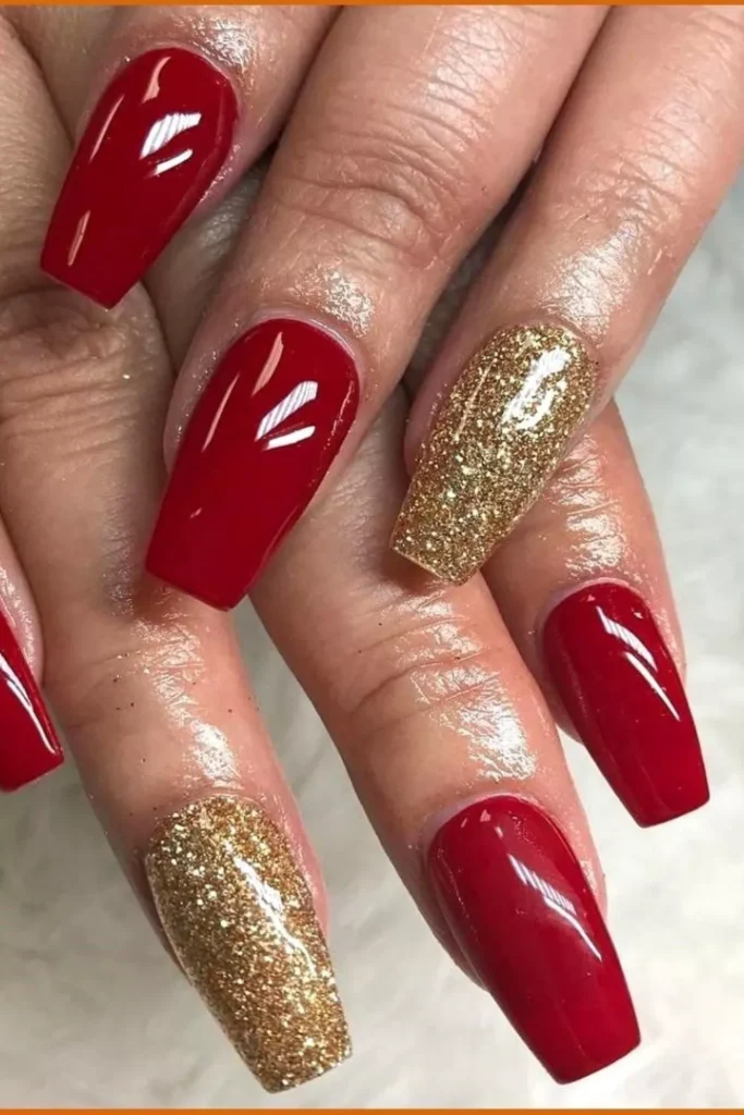 Square-shaped glossy red nails with gold glitter accent nails on two fingers.