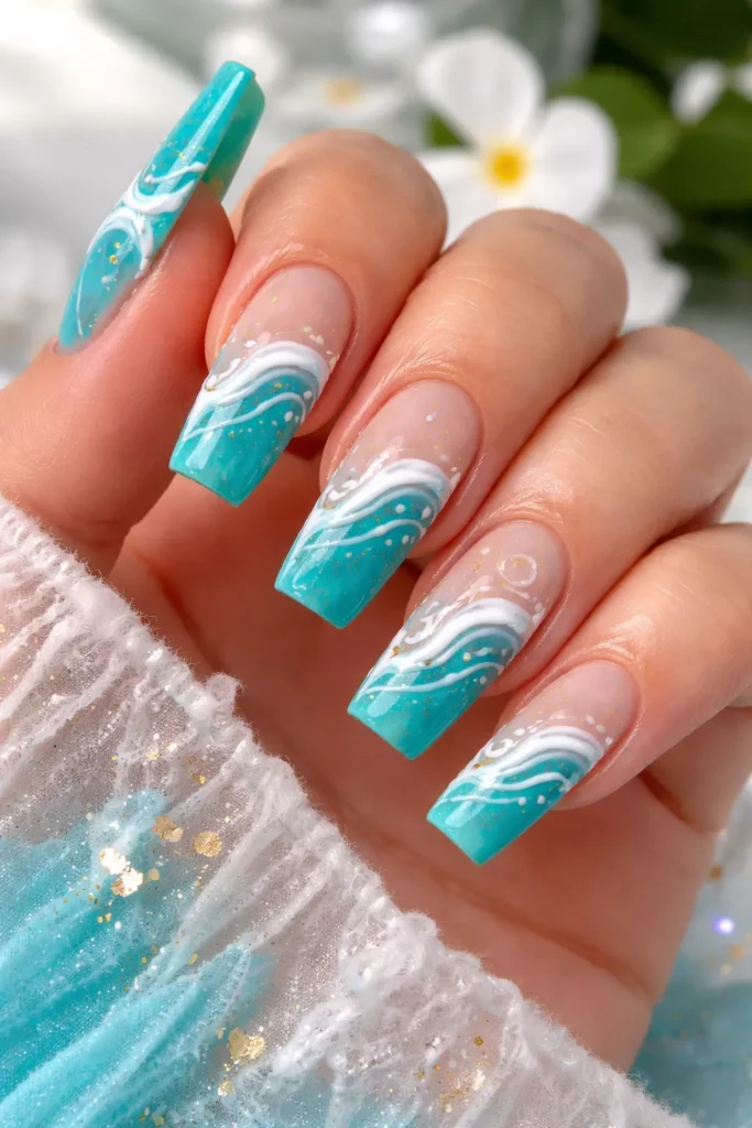 Turquoise nails with white wave art and gold flecks.