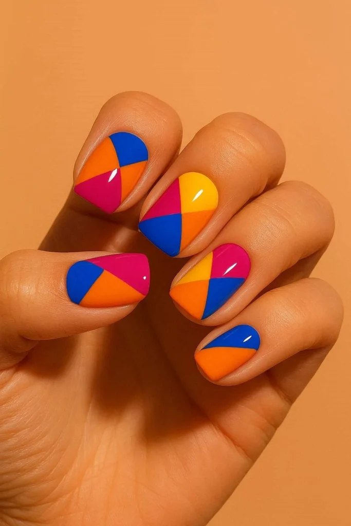 Short coffin nails with bold magenta blue and yellow colorblock nail art for Cinco de Mayo
