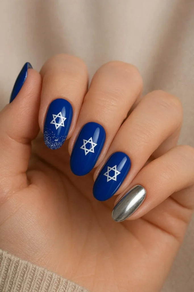 Almond nails with royal blue base and silver glitter accent for Hanukkah celebration