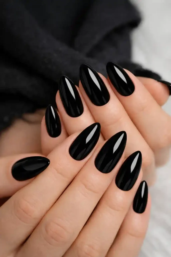 Trendy almond shaped black nails with smooth glossy finish
