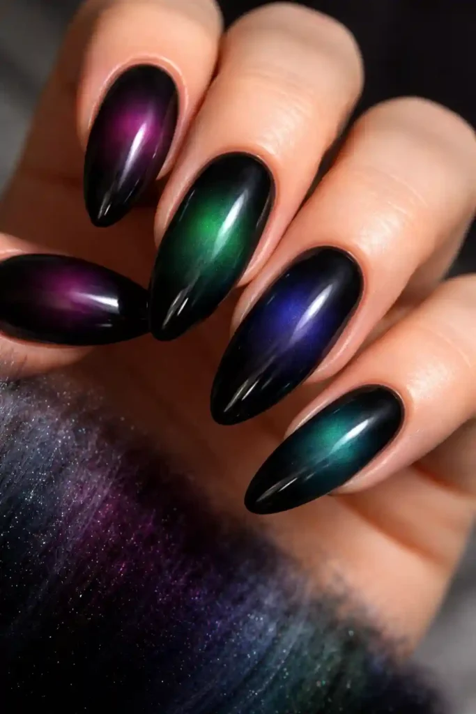 Black aura nails with jewel toned gradient manicure design
