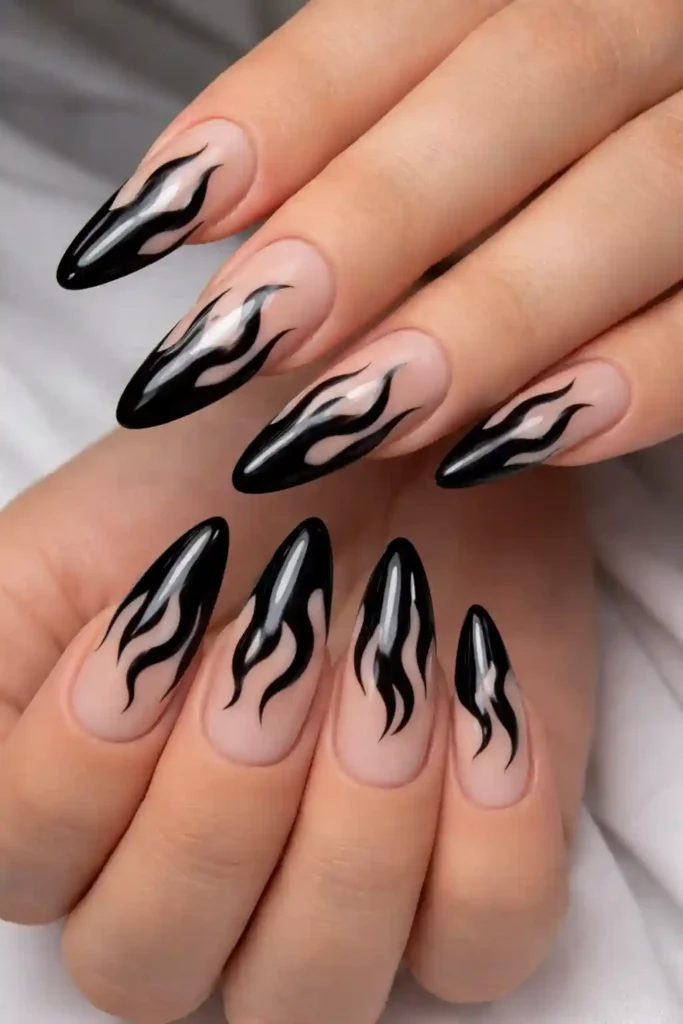 Trendy black flame design on nude almond shaped nails