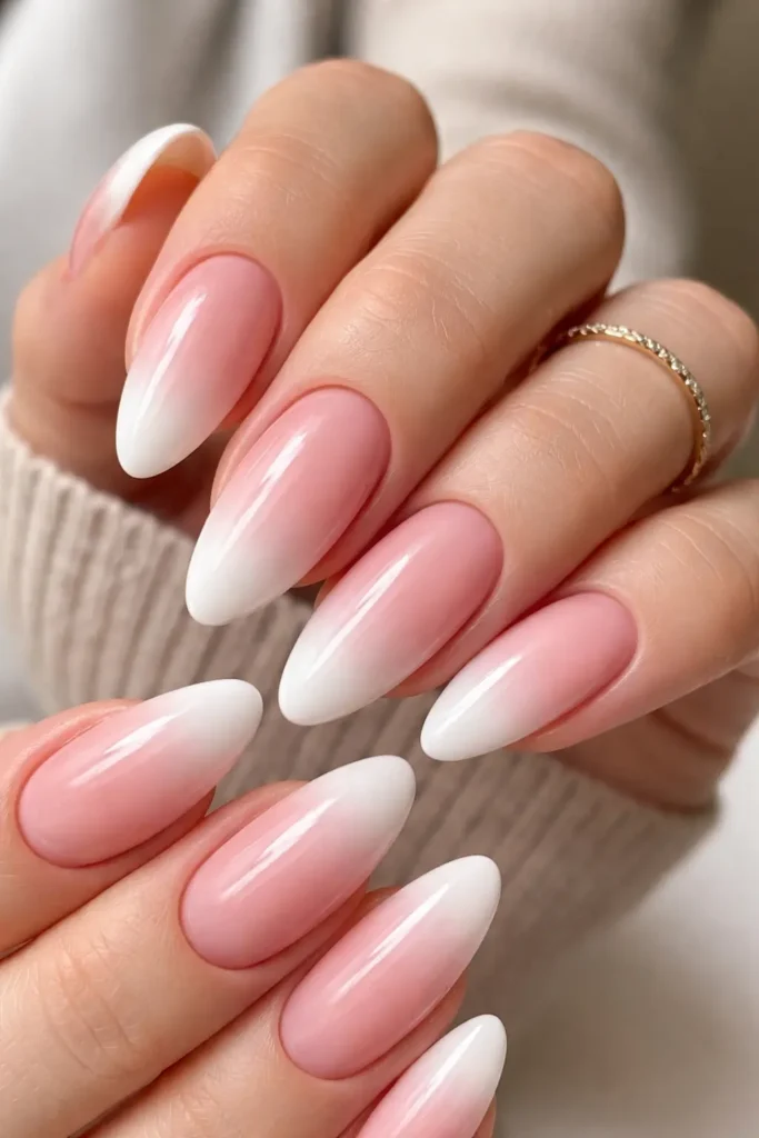 Ombre french tip nails with blush to white gradient baby boomer effect on almond nails