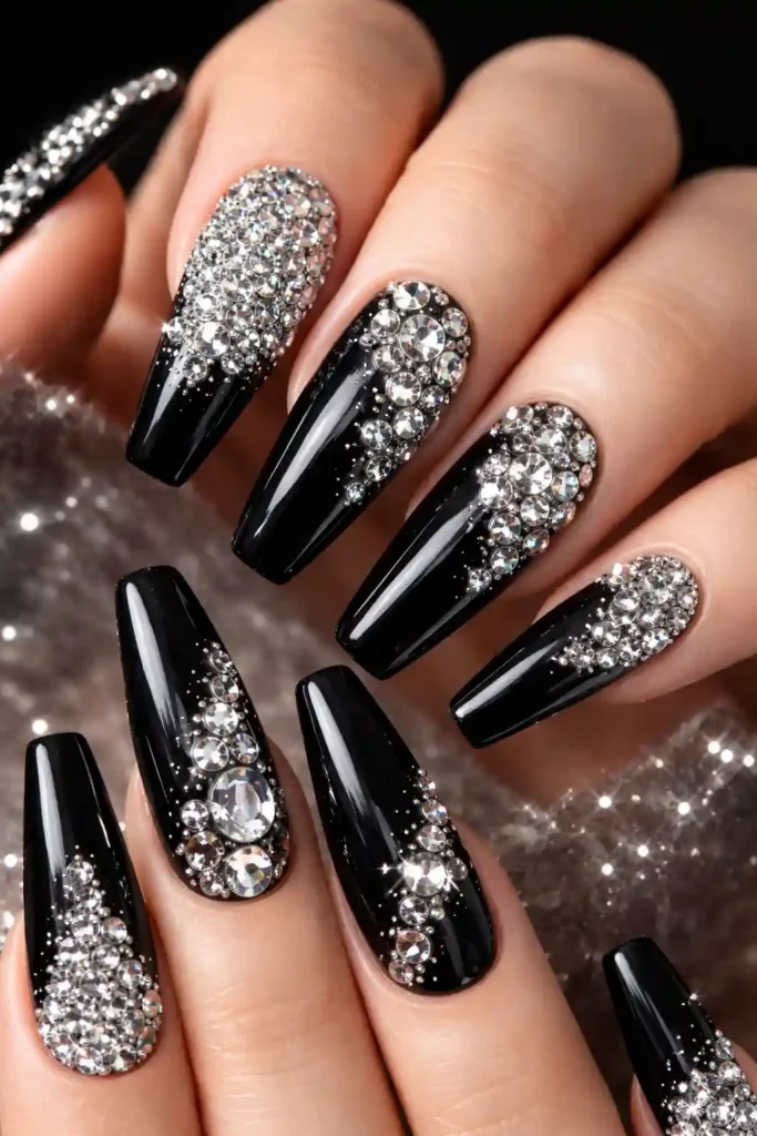 Black stiletto nails with sparkling rhinestone crystal design