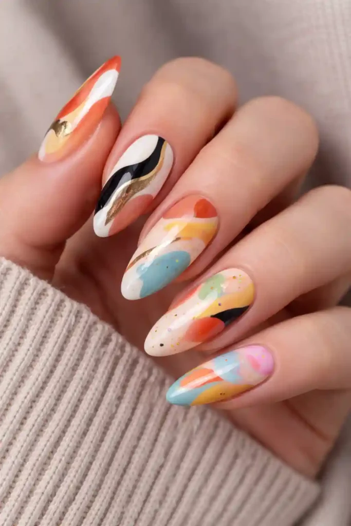 Abstract art almond nails with bold brushstrokes in cream and terracotta