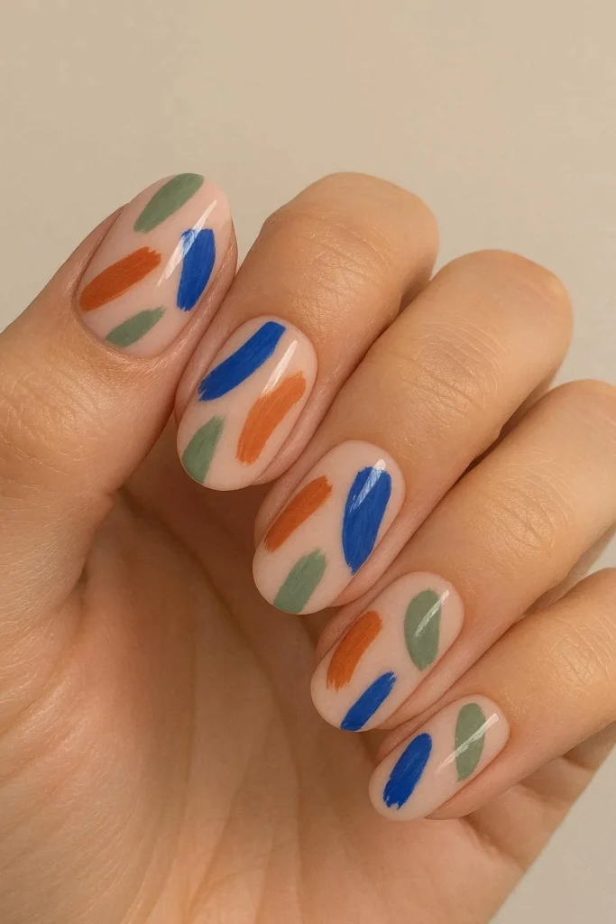 Abstract brushstroke nail art on nude acrylic base in blue terracotta