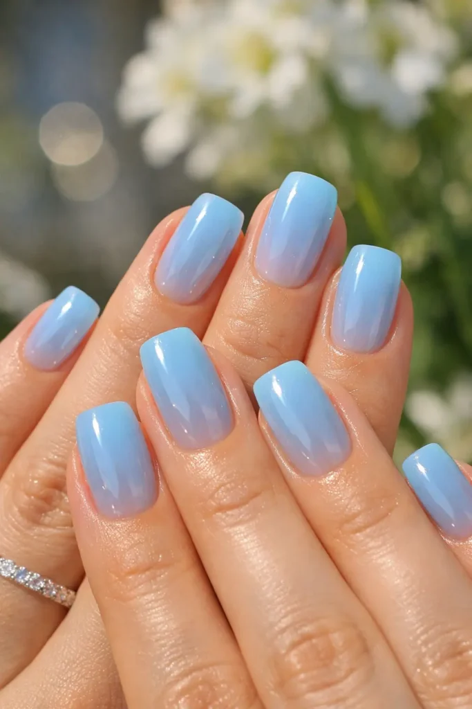 Baby blue spring nails with a sheer glossy finish on short square-shaped nails
