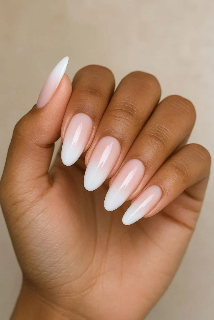 Baby boomer ombre nails blending pink into white
