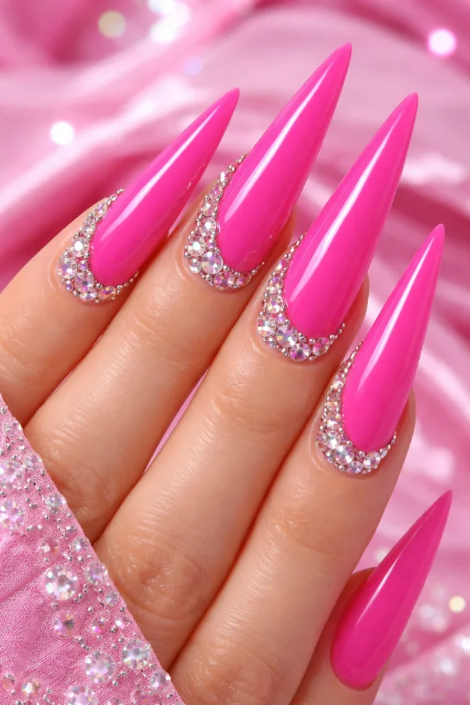 Barbie pink stiletto nails with rhinestone accents for birthday