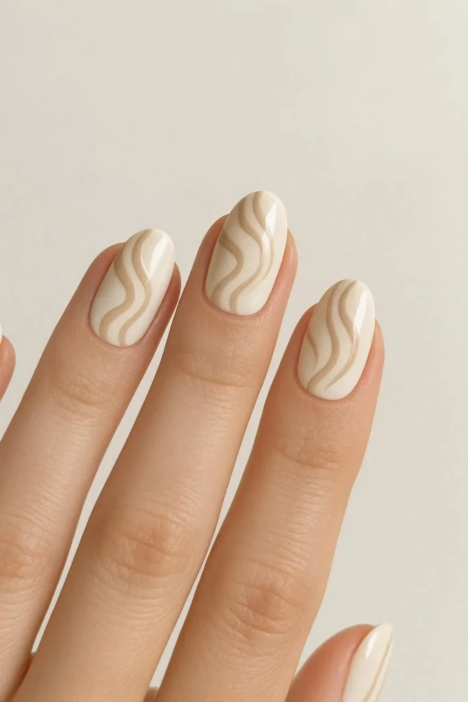 Beige and white swirl nail art design for elegant seasonal transition nails