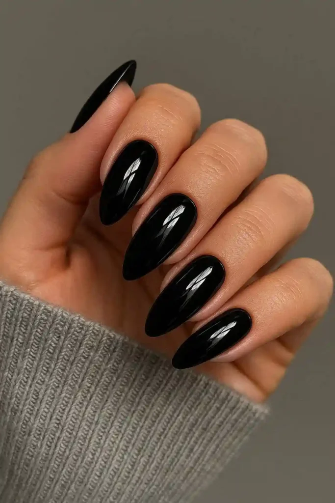 Glossy black gel nails with high-shine finish on coffin shaped nails
