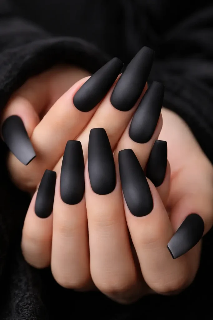 black to grey ombre nails with matte finish on long coffin shaped nails for a moody look
