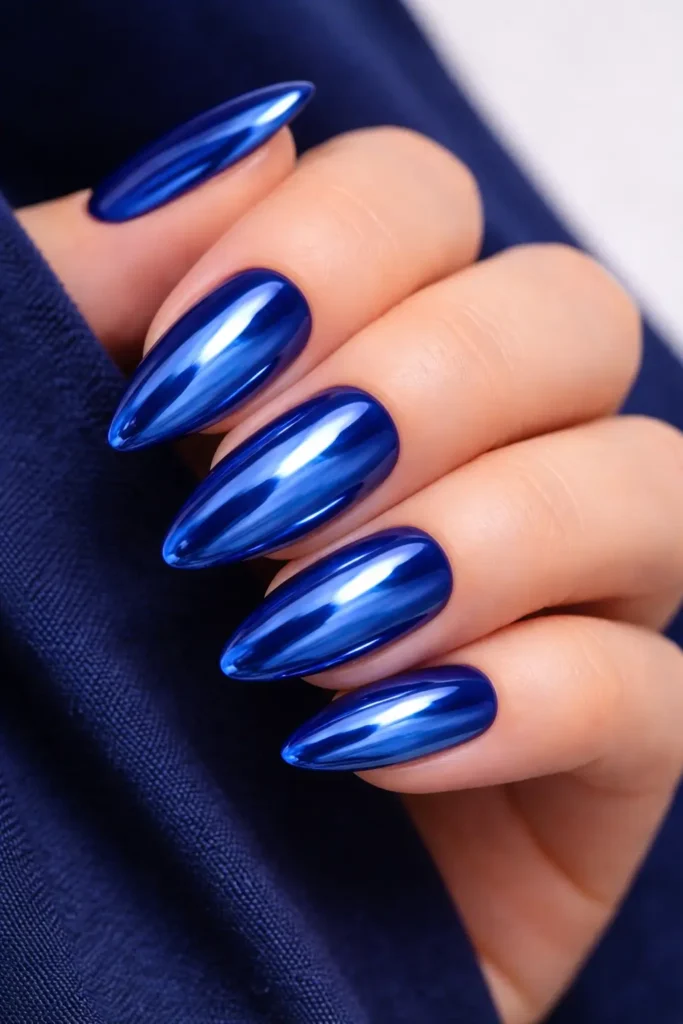 Metallic blue chrome nails on almond shape