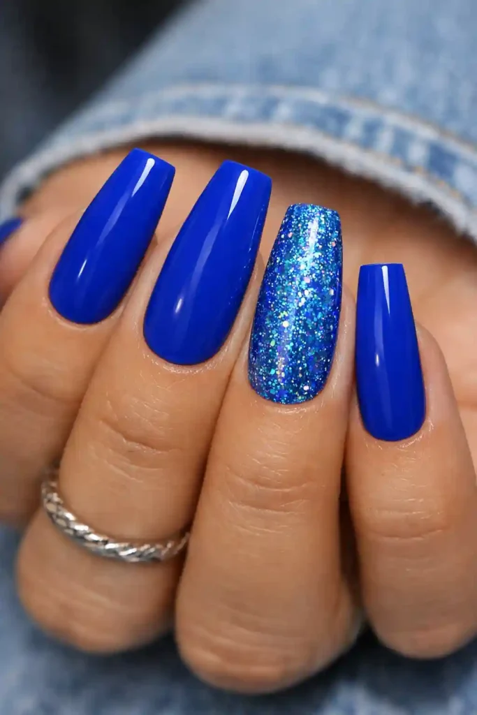 Bold cobalt blue coffin nails with glitter accent on ballerina shape
