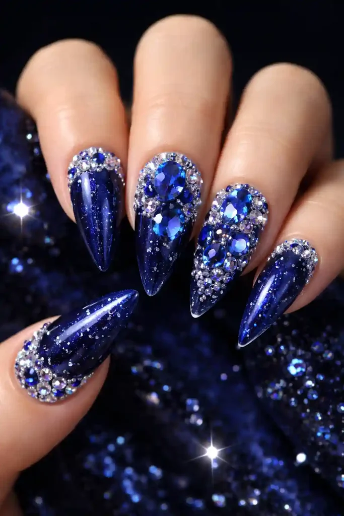 Luxurious blue gemstone nails with sapphire rhinestones on coffin shape
