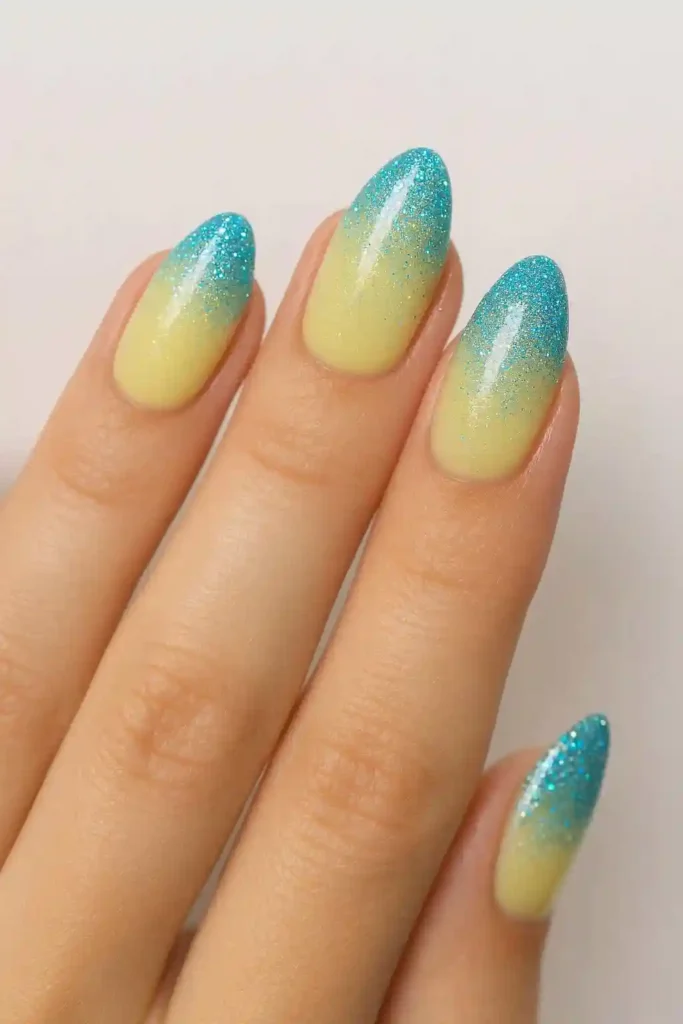 sheer lemon nails with blue glitter ombre tips