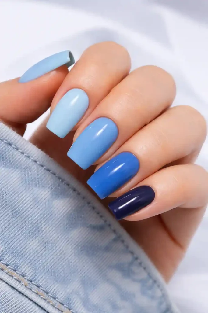 Blue gradient nails transitioning from light to midnight navy across ten fingers