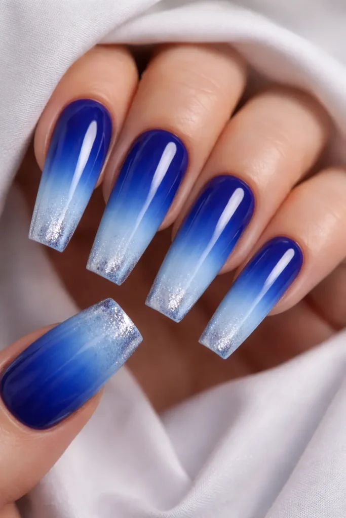 blue ombre nails fading from deep cobalt to icy baby blue on coffin shaped nails
