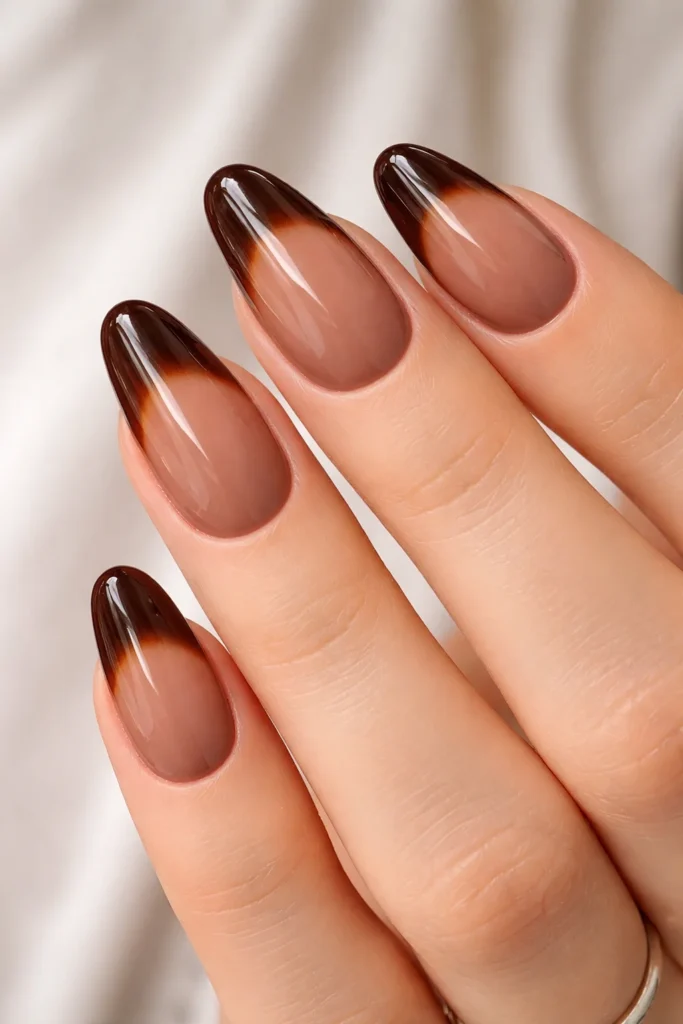 Brown gel nails over a sheer nude base