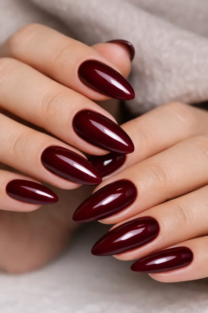 Glossy burgundy almond nails with tapered soft point shape