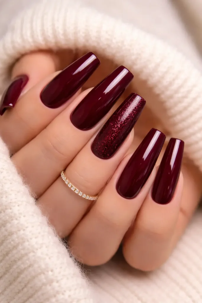 Rich burgundy coffin nails with glossy finish and shimmer accent