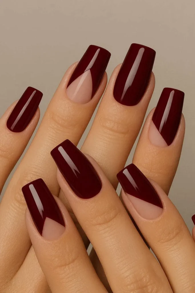 Burgundy negative space nails with geometric bare cutouts on square coffin shape
