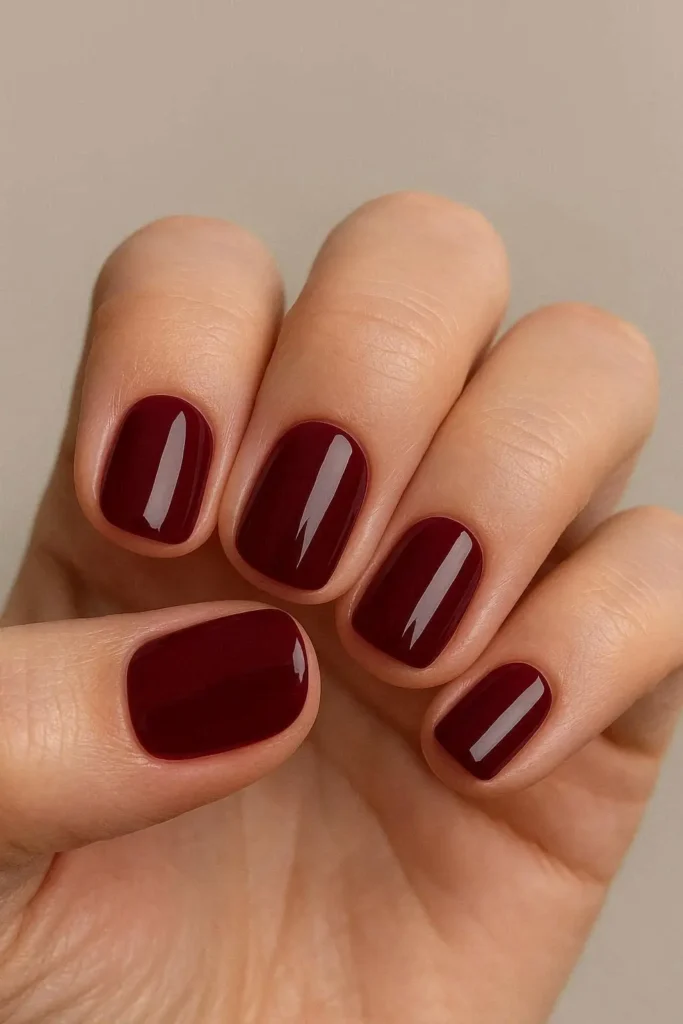 Burgundy short nails with glossy finish on trimmed square round shape
