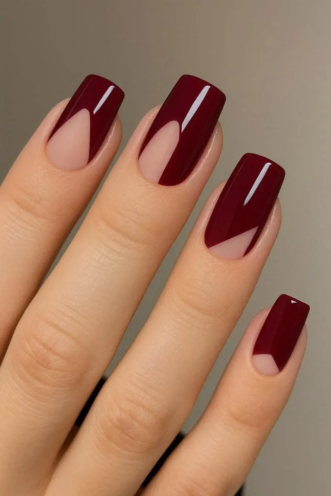 Burgundy stiletto nails with glossy finish on long pointed shape

