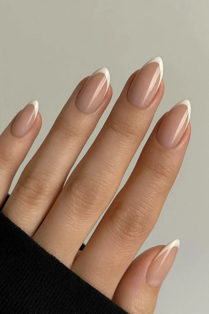 Modern slim French tip nails on almond shape
