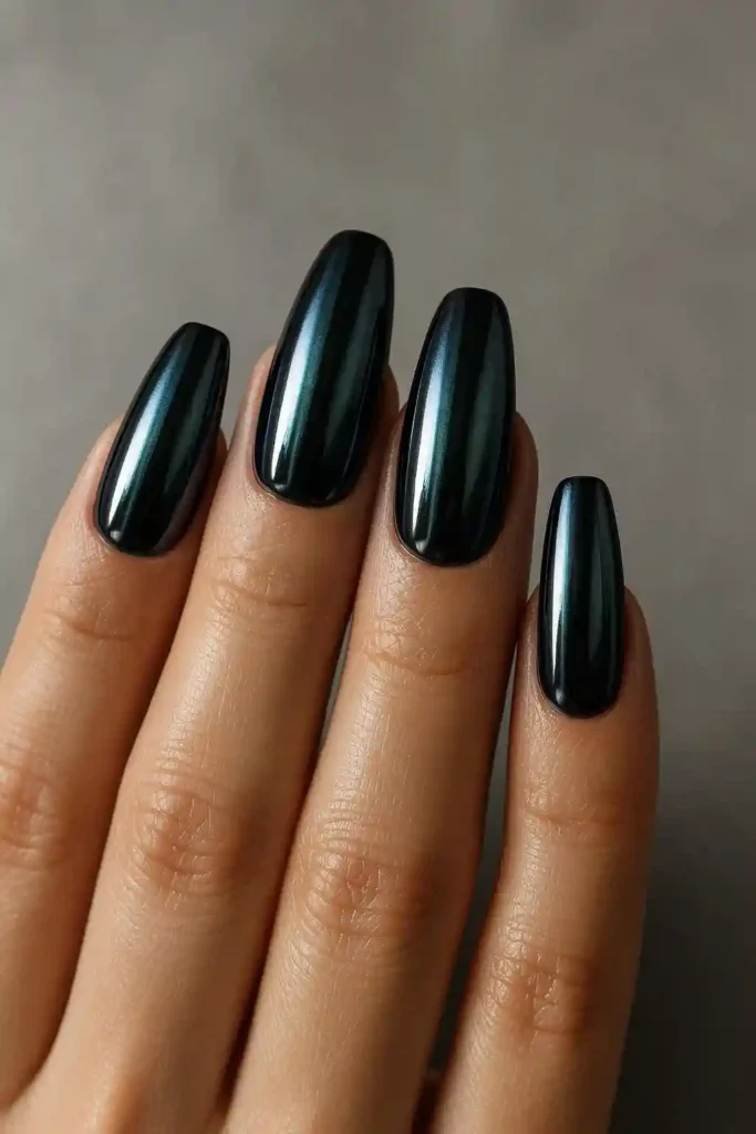 Dark chrome nails in deep navy with metallic chrome powder finish on coffin nails