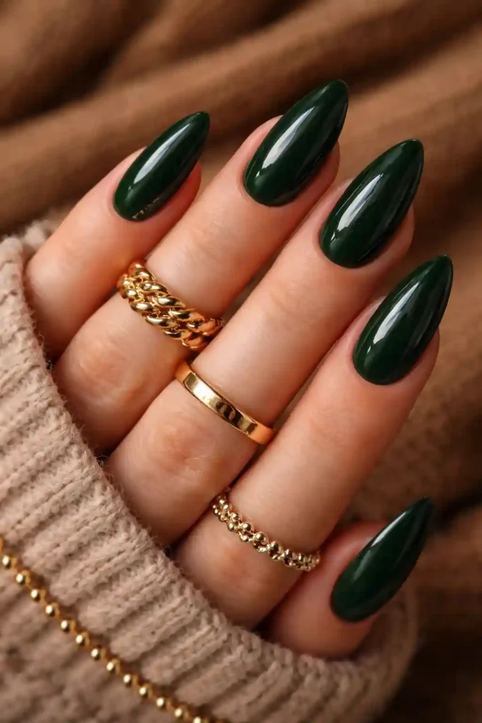 Dark forest green almond nails with rich velvet-like finish