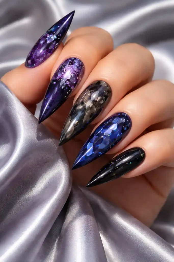 Dark gemstone nails in amethyst purple and obsidian black on stiletto nails
