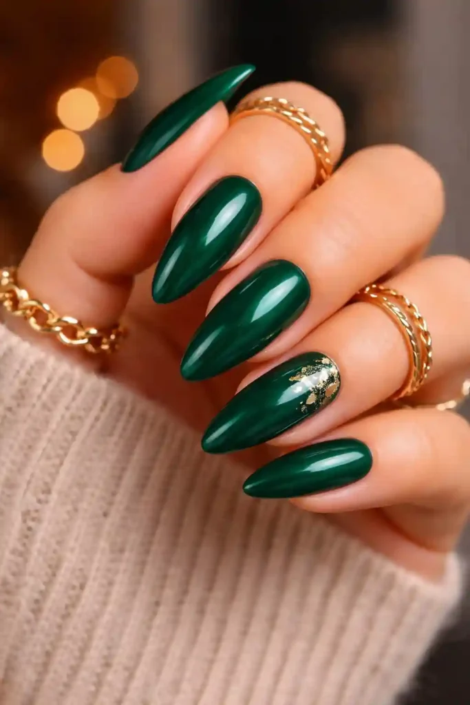 Deep emerald green almond nails with high-gloss jewel-tone polish