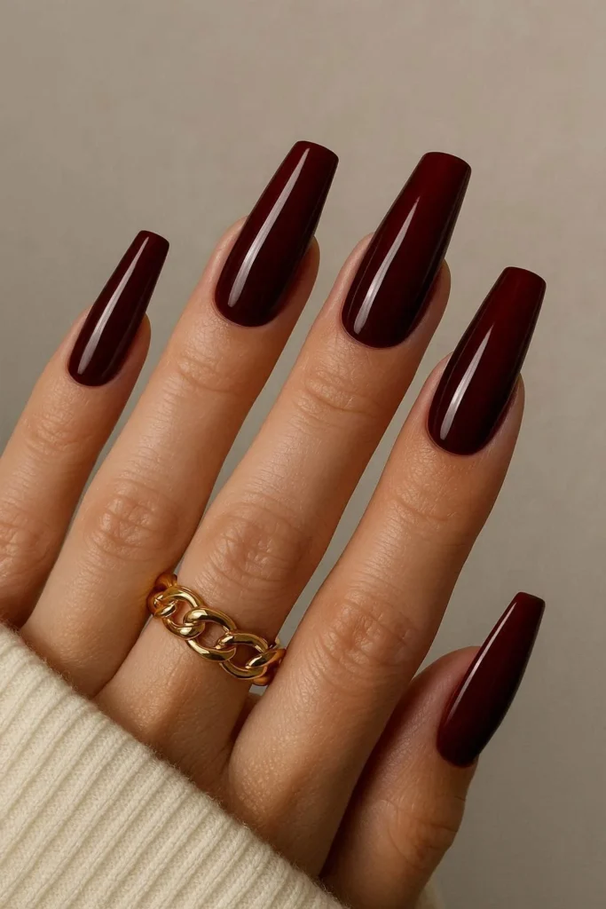 Deep oxblood red coffin acrylic nails with glossy finish