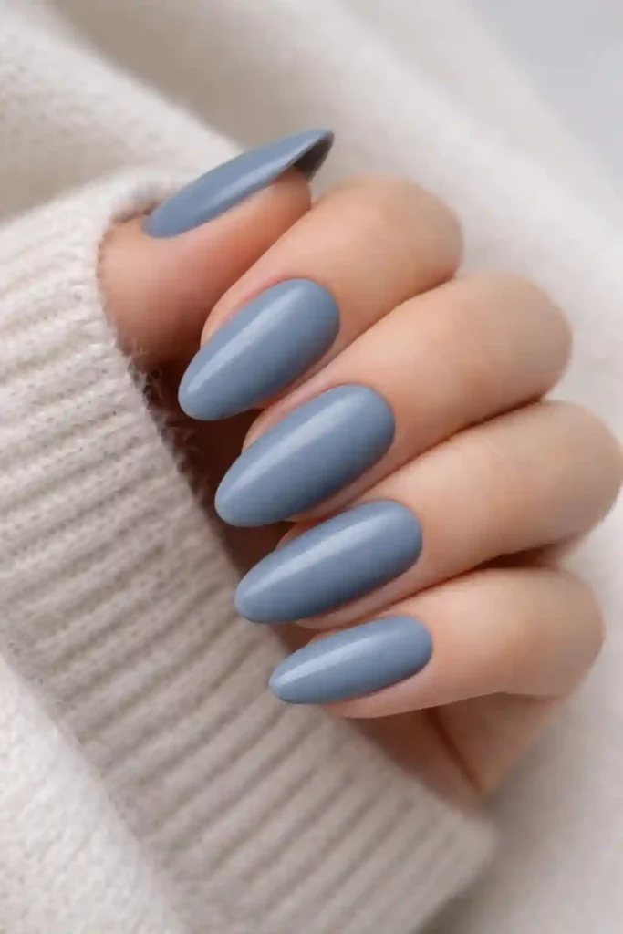 Muted dusty blue nails with satin finish on oval shape
