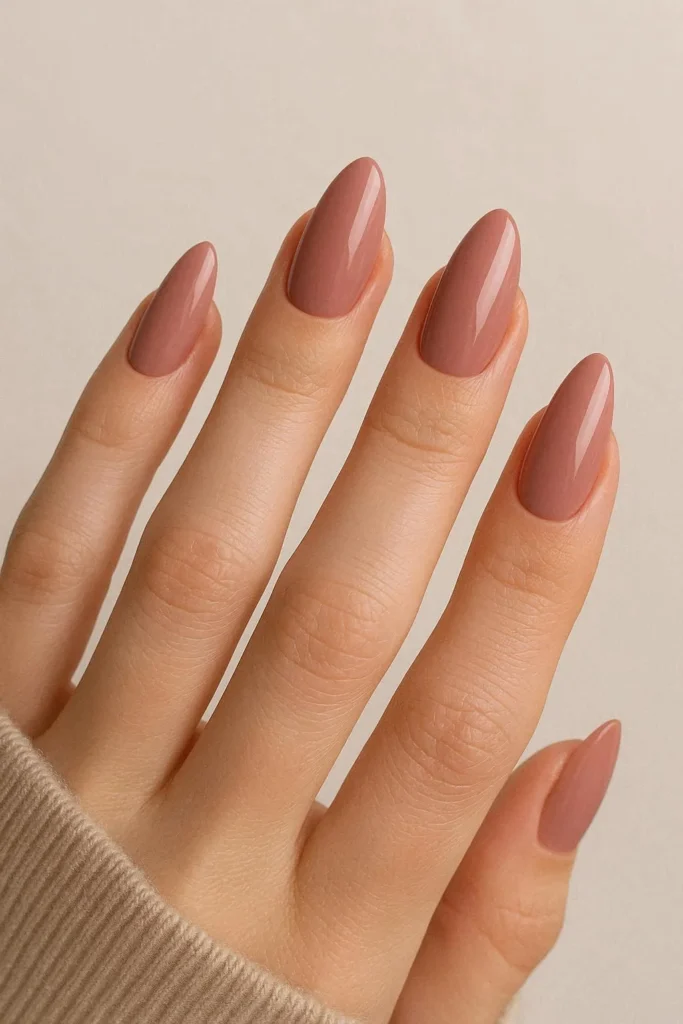 Dusty rose almond shaped acrylic nails with muted pink tone