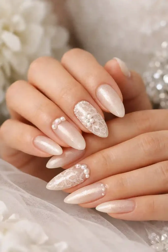 Elegant wedding almond nails with pearl accents and ivory polish
