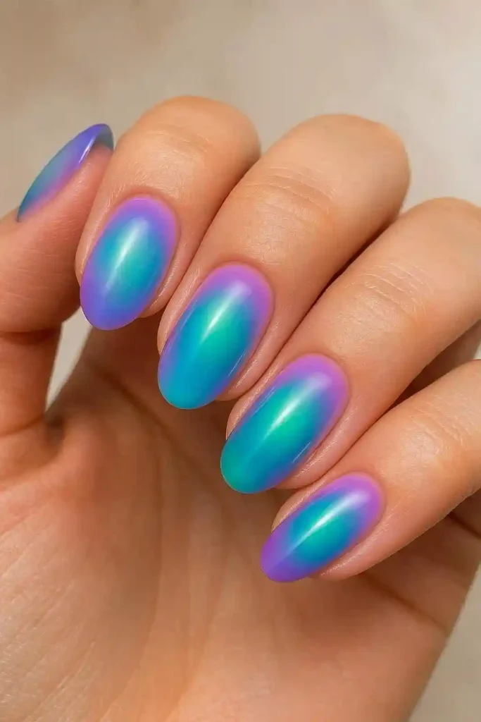Gel aura nails with soft blurred lavender to blue gradient effect
