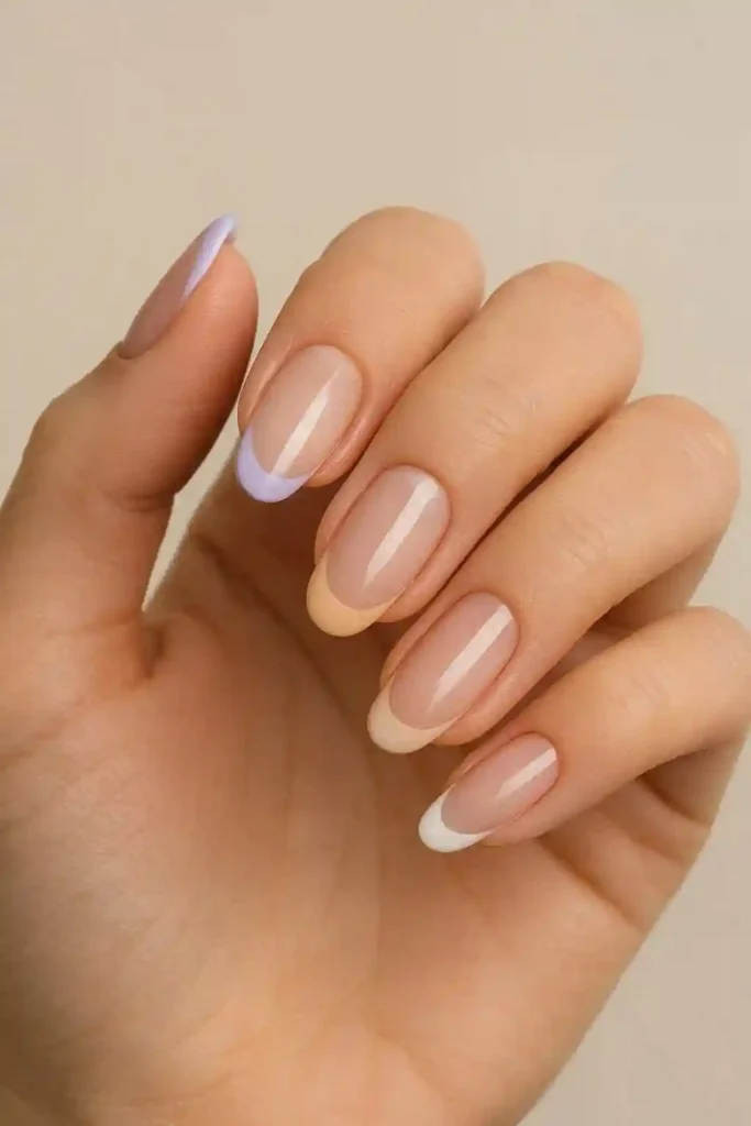Modern gel French tip nails with thin white tips on oval shaped nails
