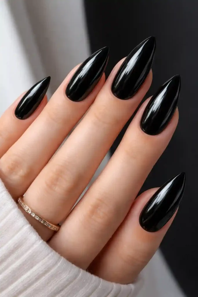 Glossy black almond nails with a high-shine mirror finish